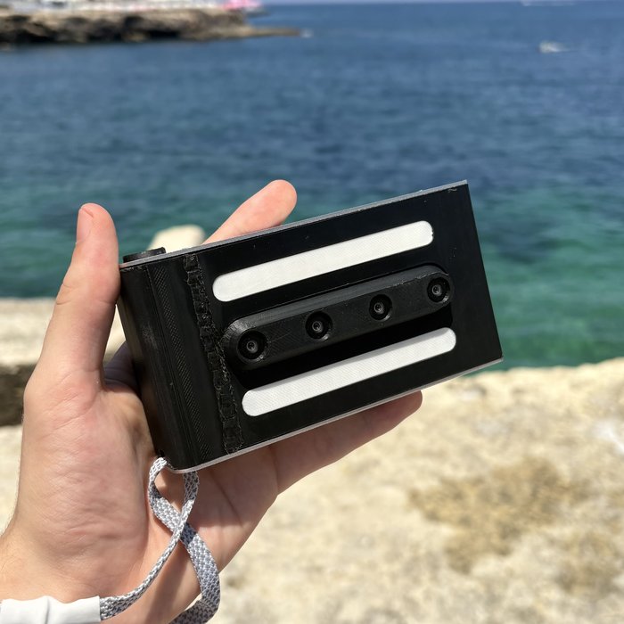 The merged. wigglegram camera prototype held in hand
